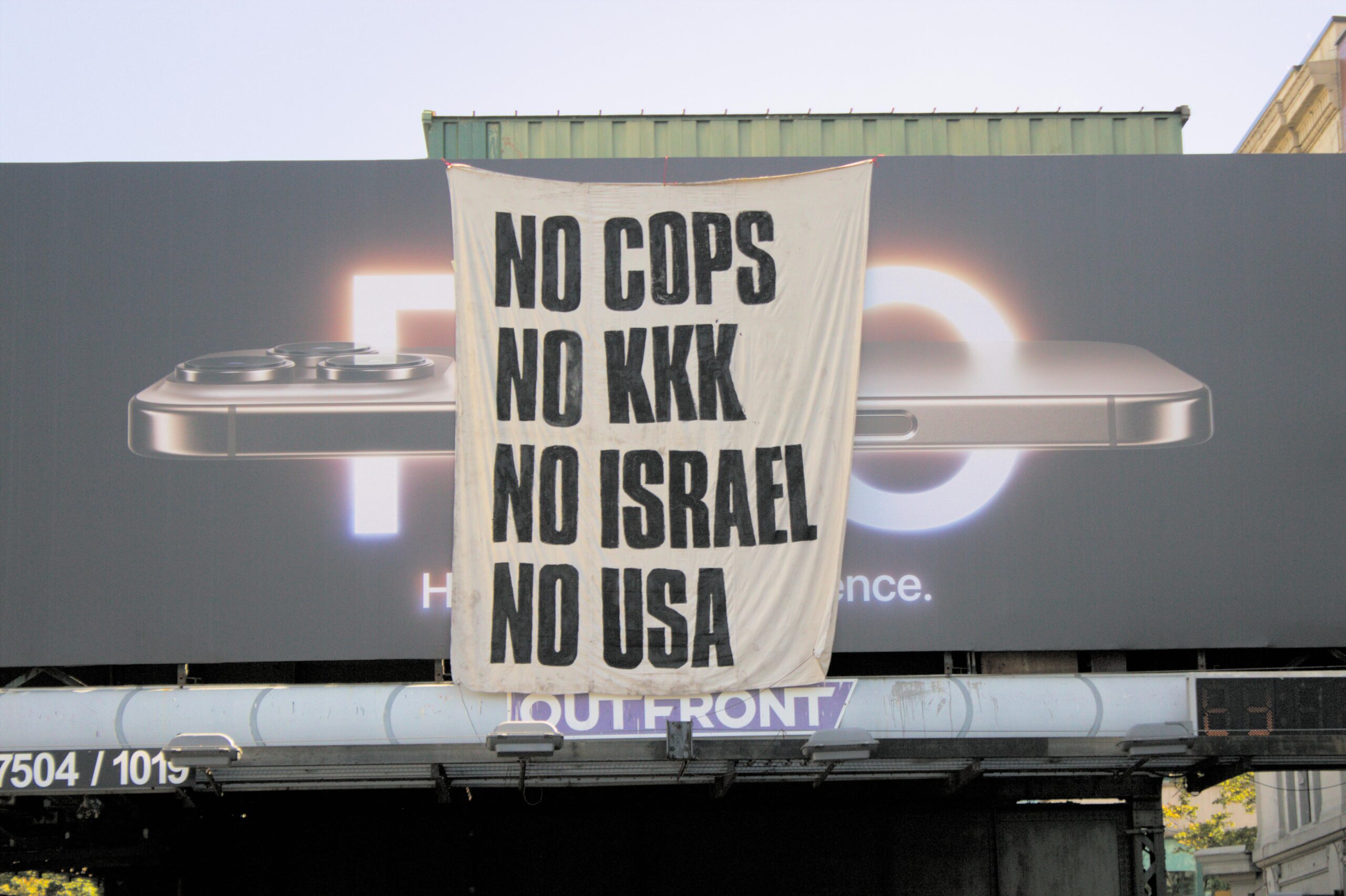 Williamsburg Banner Drop: NO COPS, NO KKK, NO ISRAEL, NO USA!